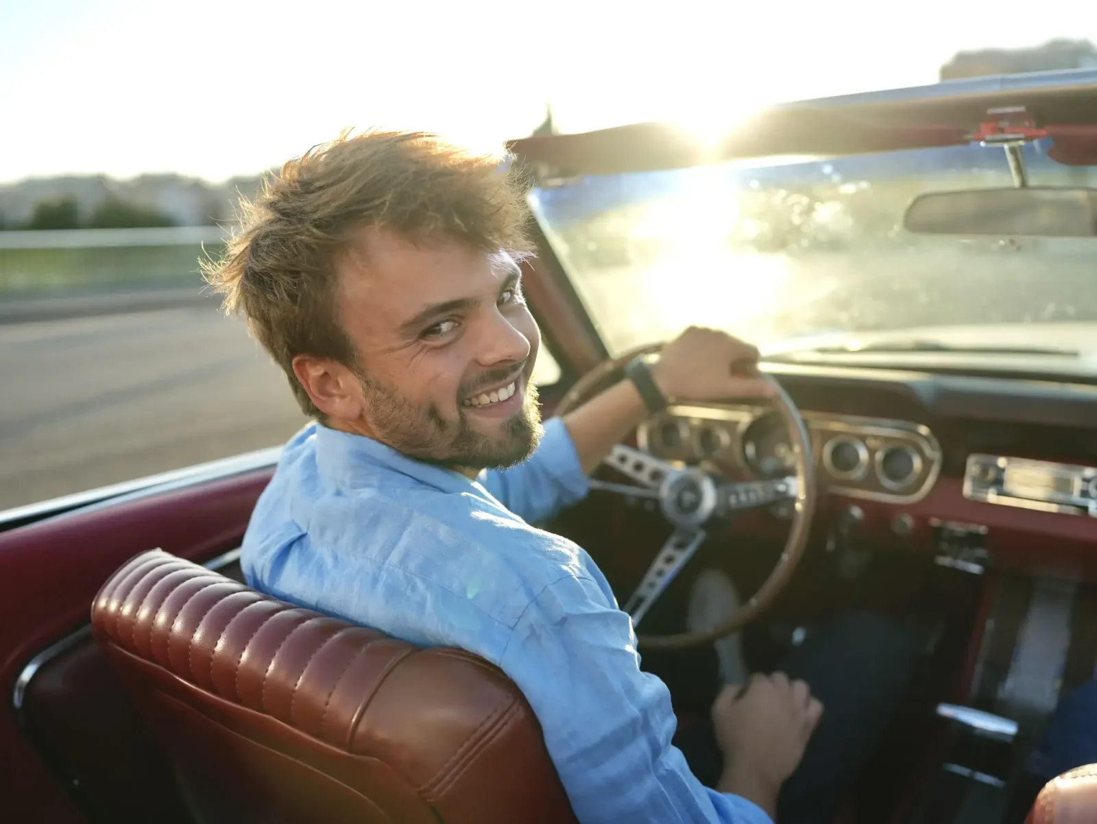 Our smiling driver-guide at the wheel of the Mustang, with its red interior